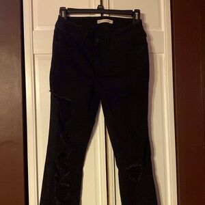 SO black jeans with manufactured rips in the legs and knees.